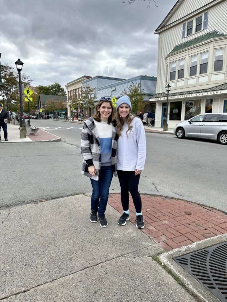 two girls standing on the corner of a street in Bar Harbor, Maine
