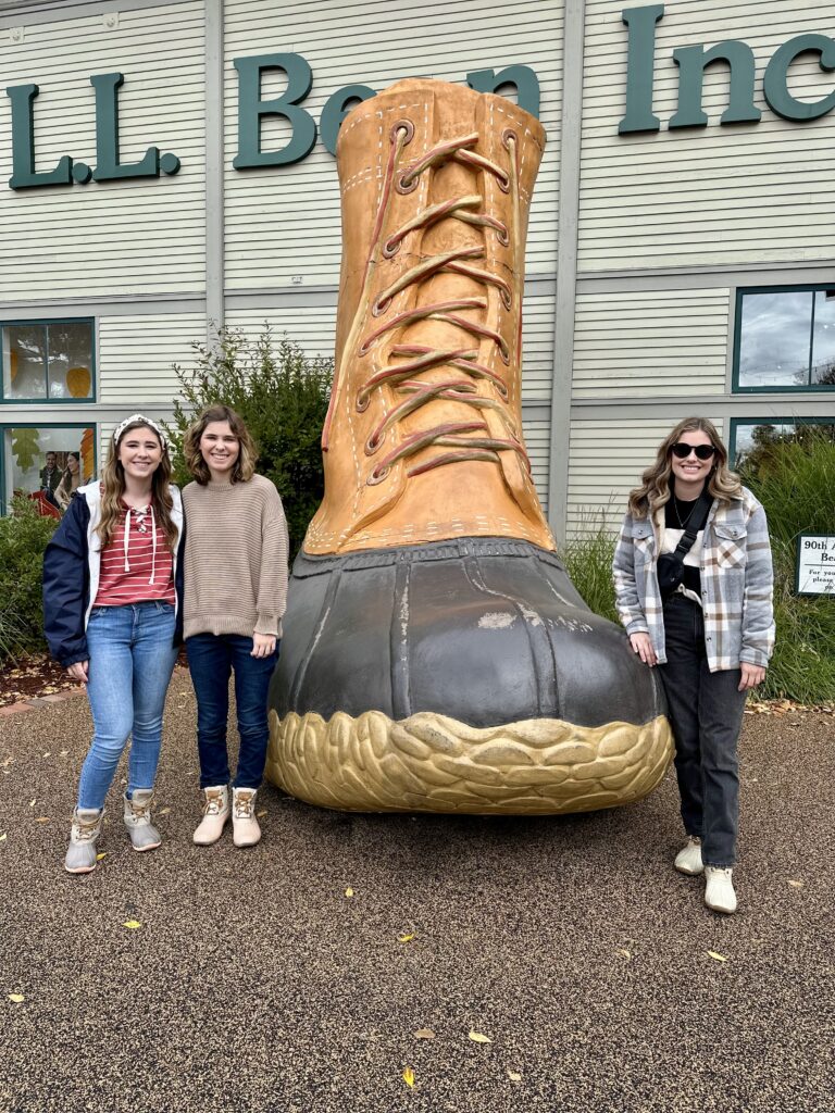 three girls in front of LL bean boot in freeport, maine