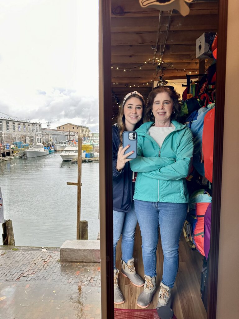mom and daughter looking into a mirror in portland, maine