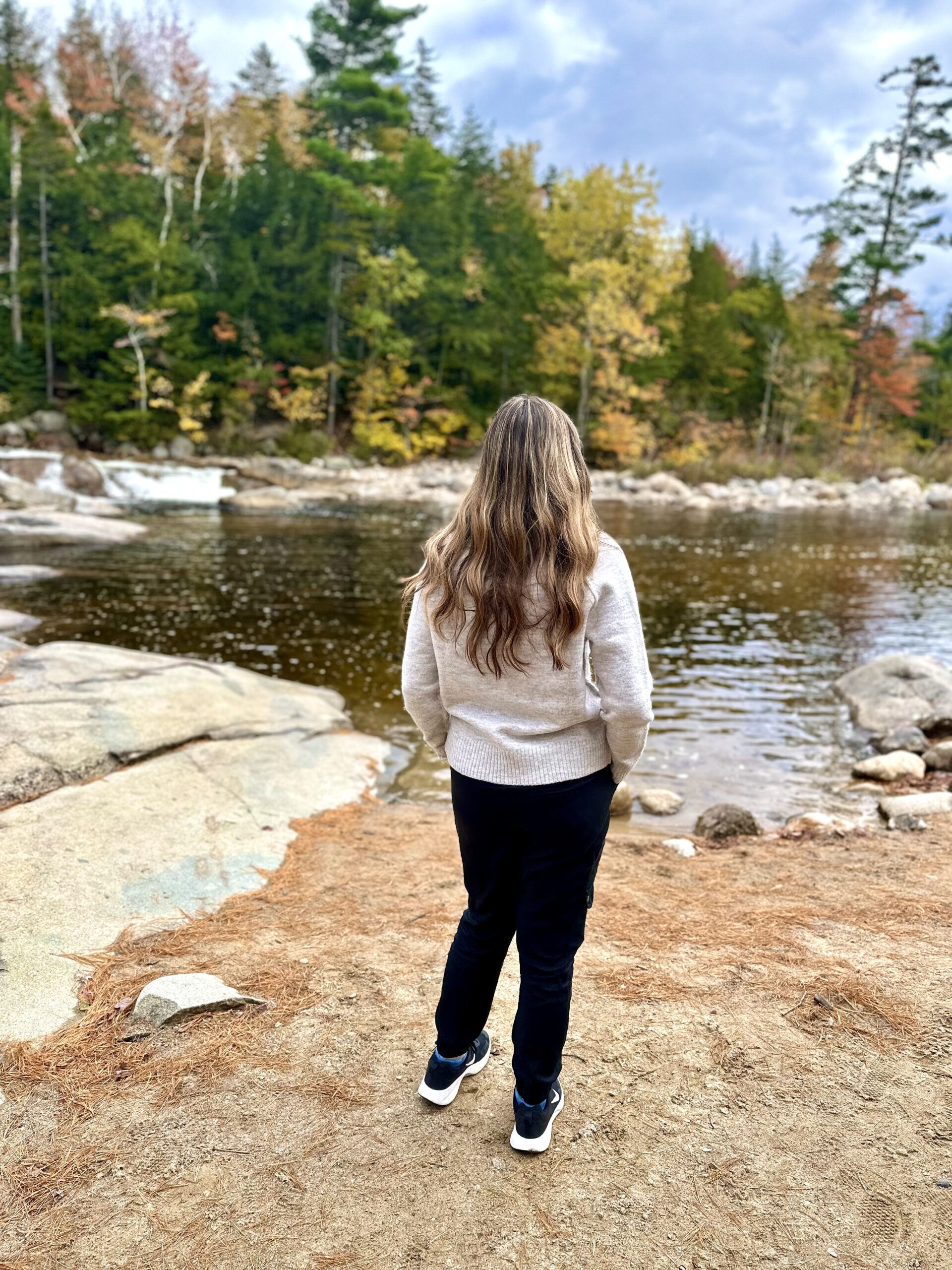 girl looking at lower falls on kancamagus highway
